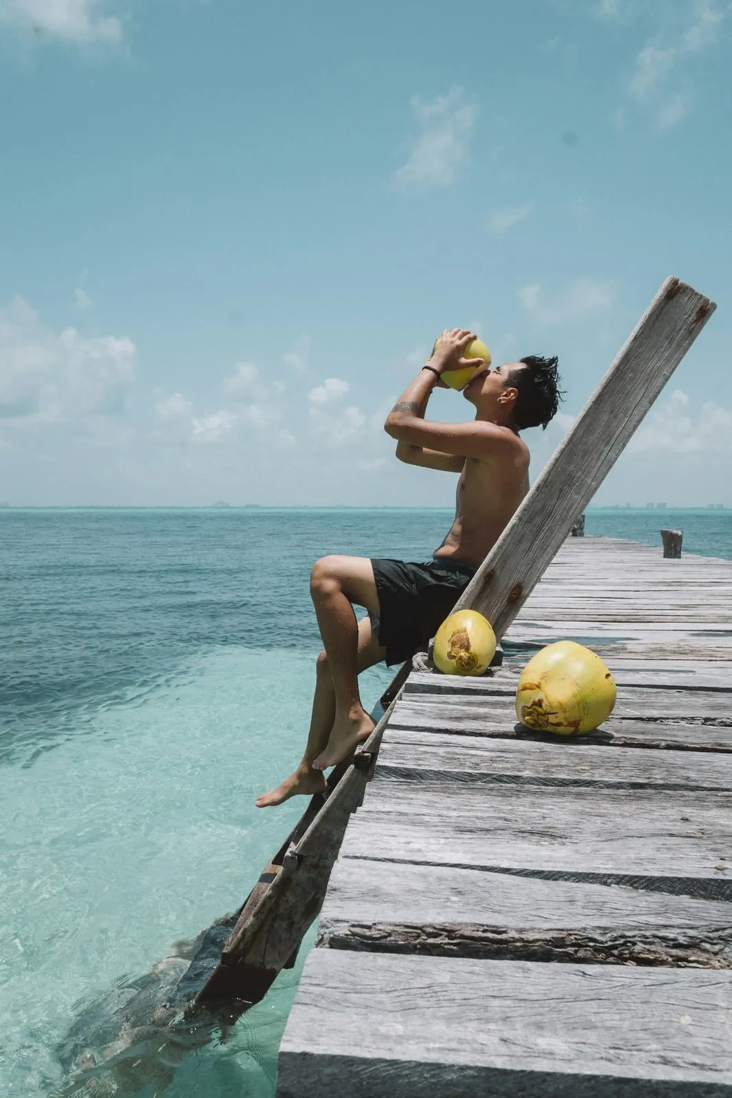 Guest relaxing on a pier over turquoise water at Isla Mujeres